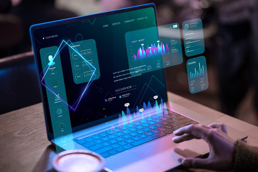 A hand on a laptop with analytics dashboards projected above the screen