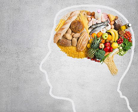Head outline whose brain is filled with food: bread, pasta, fish, eggs, fruit, vegetables and cheese