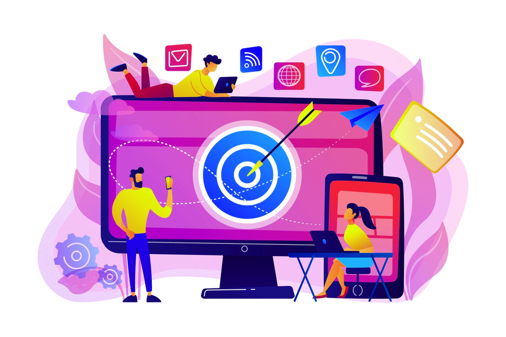 A team around a large monitor with an arrow in a target, working on laptops and phones