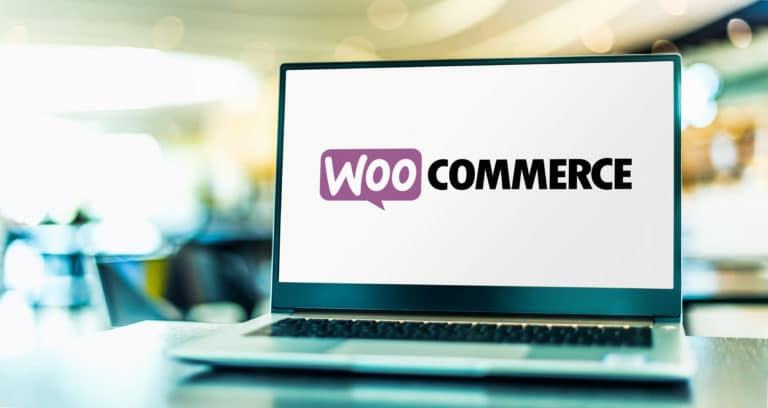 Laptop on a desk showing the WooCommerce logo