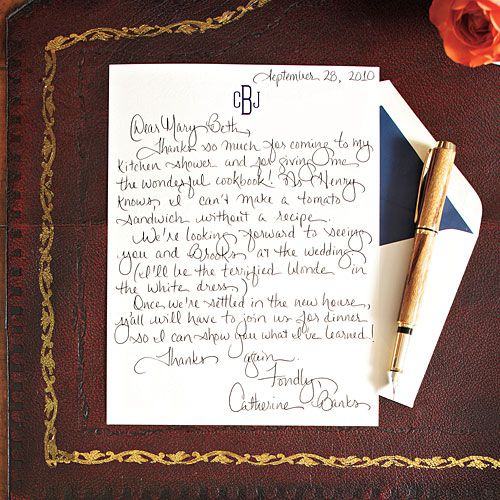Handwritten thank-you note on monogrammed stationery beside a fountain pen and envelope